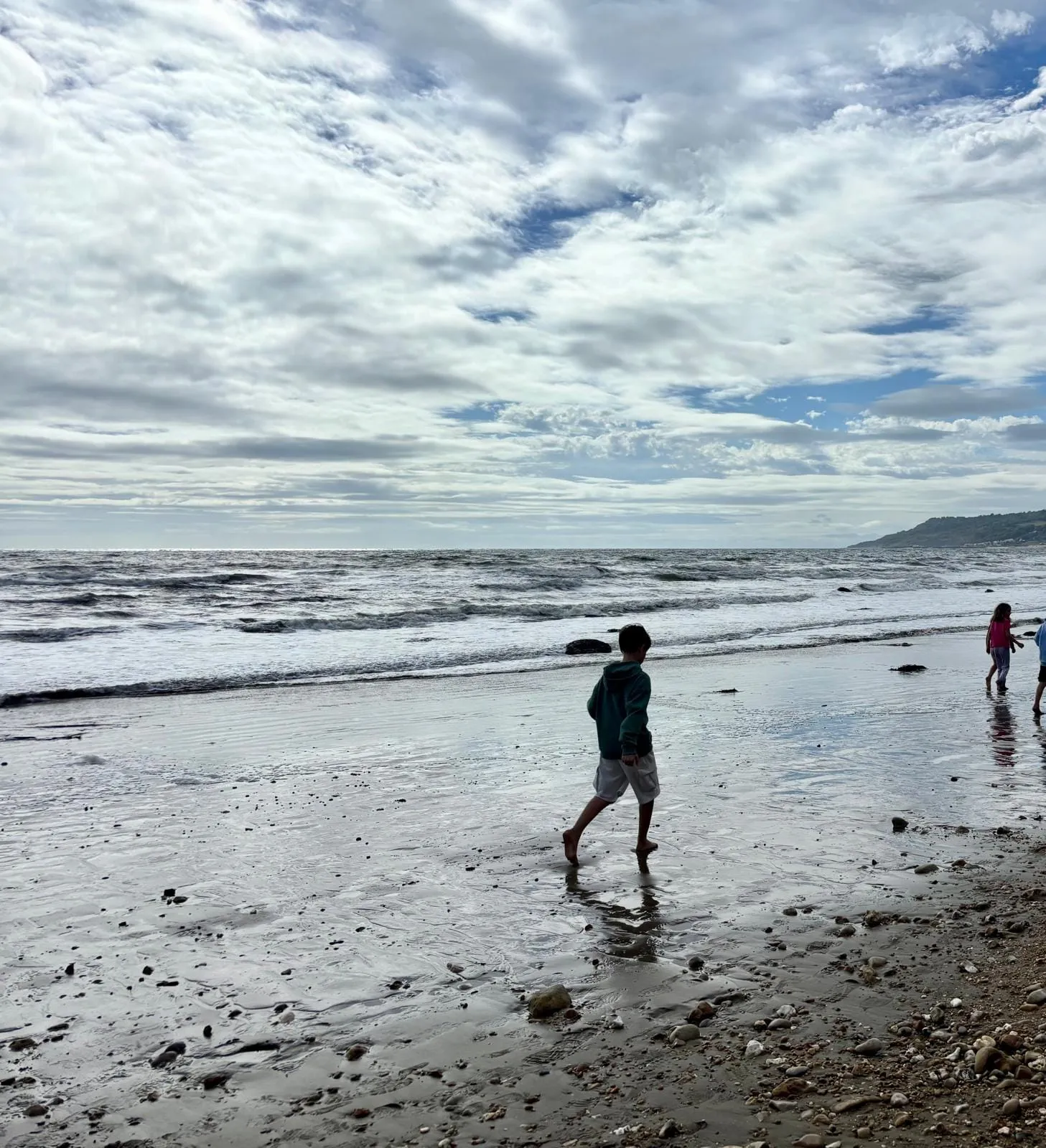 Walking along Charmouth beach at low tide after a day of fossil hunting